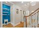 Inviting entryway with bright blue accent wall, modern decor and a staircase leading to an open landing at 10012 San Remo Pl, Wake Forest, NC 27587