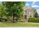 Brick two-story home with landscaped front, small balcony, and inviting front door at 10012 San Remo Pl, Wake Forest, NC 27587
