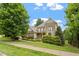 Charming brick home boasts beautiful landscaping, a balcony, and classic architecture at 10012 San Remo Pl, Wake Forest, NC 27587