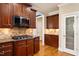Kitchen with wooden cabinets, stainless steel microwave, and gas cooktop on granite countertops at 10012 San Remo Pl, Wake Forest, NC 27587