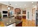 Bright open kitchen with stainless steel appliances, granite countertops, and wood cabinets at 10012 San Remo Pl, Wake Forest, NC 27587
