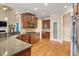 Open kitchen with stainless steel appliances, breakfast bar, pantry, and hardwood floors at 10012 San Remo Pl, Wake Forest, NC 27587