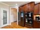 Kitchen with stainless steel refrigerator, double ovens, pantry, and wood cabinetry at 10012 San Remo Pl, Wake Forest, NC 27587