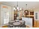 Spacious kitchen featuring dark wood cabinets, stainless appliances, and eat-in breakfast nook at 10012 San Remo Pl, Wake Forest, NC 27587