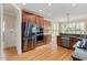 Kitchen with stainless steel refrigerator, double ovens, hardwood floors, and wood cabinets at 10012 San Remo Pl, Wake Forest, NC 27587