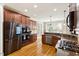 Kitchen with stainless steel appliances, double oven, hardwood floors, and granite counters at 10012 San Remo Pl, Wake Forest, NC 27587