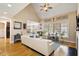 Spacious living room with vaulted ceiling, ceiling fan, open layout, and ample natural light showcasing the open floorplan at 10012 San Remo Pl, Wake Forest, NC 27587