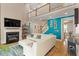 Bright living room featuring a fireplace, TV, sectional sofa, second-floor balcony and access to other rooms at 10012 San Remo Pl, Wake Forest, NC 27587