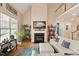 Open living room with a fireplace, and decor shelving, complemented by a large ceiling and a second-floor balcony at 10012 San Remo Pl, Wake Forest, NC 27587