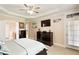 Main bedroom with tray ceilings, recessed lighting, television and ensuite bathroom access at 10012 San Remo Pl, Wake Forest, NC 27587