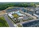 Aerial view of community featuring a pool, clubhouse, playground, and townhomes surrounded by lush green spaces at 1008 Whistler St, Durham, NC 27713