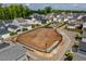 Aerial view of community garden and playground among colorful homes, fostering a vibrant and active neighborhood at 1008 Whistler St, Durham, NC 27713