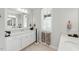 A bright bathroom has a large mirror, a walk-in shower, and a soaking tub, creating a spa-like retreat at 1008 Whistler St, Durham, NC 27713