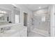 A bright bathroom has a glass-enclosed shower, and a soaking tub, creating a spa-like retreat at 1008 Whistler St, Durham, NC 27713