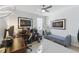 A well-lit room has two paintings, a ceiling fan, a modern desk, and a large window at 1008 Whistler St, Durham, NC 27713