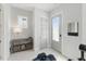 Bright entryway featuring a console table, coat rack, and a light gray front door with a glass window at 1008 Whistler St, Durham, NC 27713