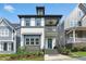 A beautiful two-story home showcases a welcoming front porch, elegant exterior, and lush landscaping at 1008 Whistler St, Durham, NC 27713