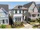 Charming two-story home boasts a covered porch and balcony, surrounded by neatly manicured landscaping at 1008 Whistler St, Durham, NC 27713