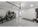 A spacious garage with epoxy floors features additional refrigerator and access door at 1008 Whistler St, Durham, NC 27713