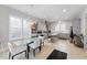 Open concept kitchen and dining area with gray cabinets and stainless steel appliances and modern light fixture at 1008 Whistler St, Durham, NC 27713