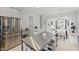 Open concept kitchen with stainless steel appliances, gray cabinets, and a large center island with bar seating at 1008 Whistler St, Durham, NC 27713