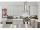 Modern kitchen featuring gray cabinets, stainless steel appliances, and a bright white backsplash at 1008 Whistler St, Durham, NC 27713