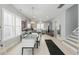 Open concept kitchen and dining area with gray cabinets and stainless steel appliances with hardwood floors at 1008 Whistler St, Durham, NC 27713