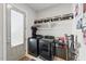 Well-equipped laundry room with modern washer and dryer, shelving, and storage cabinets for supplies at 1008 Whistler St, Durham, NC 27713