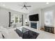 Bright living room with fireplace, large windows and lots of natural light with hardwood floors at 1008 Whistler St, Durham, NC 27713