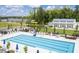 Community pool with lounge chairs, umbrellas, clubhouse, and surrounding landscaped areas creates a great recreation area at 1008 Whistler St, Durham, NC 27713