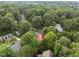 An aerial perspective showcases a home with a red roof nestled within a vibrant, green, and serene neighborhood at 101 Joel Ct, Cary, NC 27513