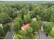 Stunning aerial view of a home with a striking red roof nestled among lush greenery at 101 Joel Ct, Cary, NC 27513