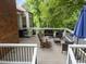 Back deck with an umbrella, and assorted outdoor seating including a wooden rocking chair at 101 Joel Ct, Cary, NC 27513