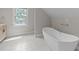 Elegant bathroom with a freestanding tub, modern fixtures, and tile flooring at 101 Joel Ct, Cary, NC 27513