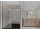 Luxurious bathroom featuring a glass-enclosed shower and a double sink vanity at 101 Joel Ct, Cary, NC 27513