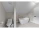 Bright bathroom featuring a freestanding tub, modern fixtures, and patterned tile flooring at 101 Joel Ct, Cary, NC 27513