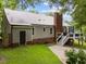 Back exterior view of house with metal roof, deck, and backyard at 101 Joel Ct, Cary, NC 27513