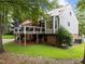 Back exterior view of the house, featuring a metal roof, brick, and landscaped yard at 101 Joel Ct, Cary, NC 27513