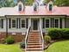 Beautiful home with a vibrant red roof, complemented by lush greenery and brick accents at 101 Joel Ct, Cary, NC 27513