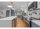 Stylish kitchen with stainless appliances, gray cabinets, quartz counters, and hardwood floors at 101 Joel Ct, Cary, NC 27513