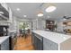 Modern kitchen with stainless steel appliances, island with seating, and an adjacent breakfast nook at 101 Joel Ct, Cary, NC 27513