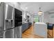Modern kitchen featuring stainless steel appliances, a large island, and hardwood floors at 101 Joel Ct, Cary, NC 27513