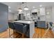 Modern kitchen with stainless steel appliances, sleek countertops, and bar stool seating at the island at 101 Joel Ct, Cary, NC 27513