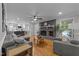 Bright open-concept living room with a fireplace and view into modern kitchen at 101 Joel Ct, Cary, NC 27513