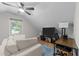 Attic living room features a ceiling fan, hardwood floors, and a window view at 101 Joel Ct, Cary, NC 27513
