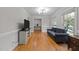 Spacious living room with a comfortable couch and hardwood floors offering versatility at 101 Joel Ct, Cary, NC 27513