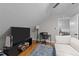 Attic living room features a ceiling fan, hardwood floors, and an adjacent room at 101 Joel Ct, Cary, NC 27513