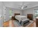 Warm bedroom with hardwood floors, natural light, a ceiling fan, and classic furnishings at 101 Joel Ct, Cary, NC 27513