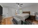 Cozy main bedroom with hardwood floors, a ceiling fan, and an attached bathroom at 101 Joel Ct, Cary, NC 27513