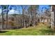 Lush backyard with lake view, mature trees, and verdant green grass for outdoor enjoyment at 1013 Sagamore Dr, Louisburg, NC 27549